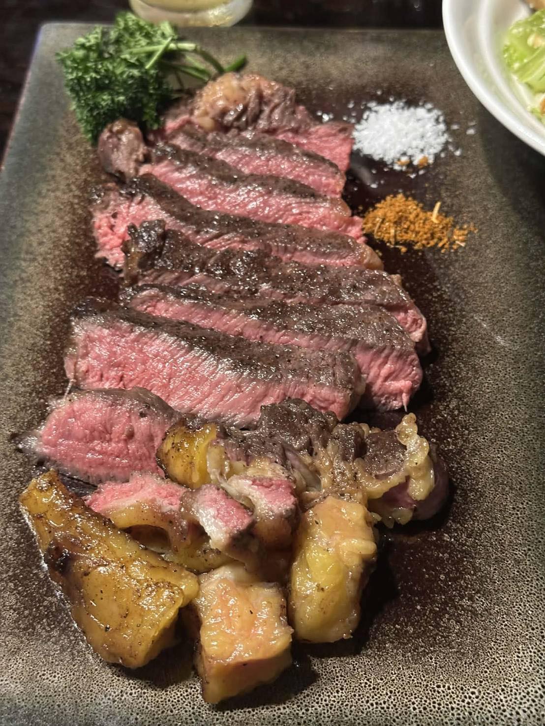 Sliced Australian Steak with sides at Damn Yankees Steak